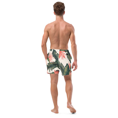 Man wearing swim trunks with tropical floral pattern.