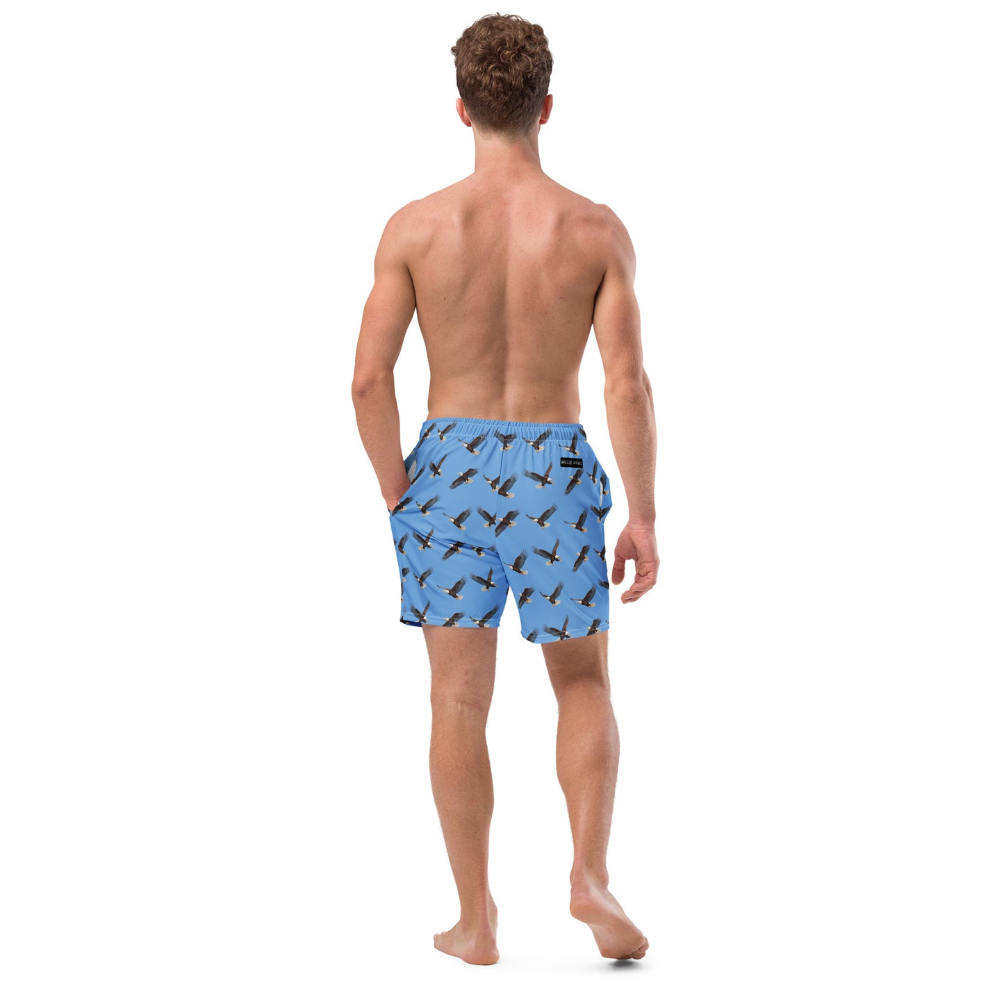 Man wearing blue swim trunks with pattern of bald eagles.