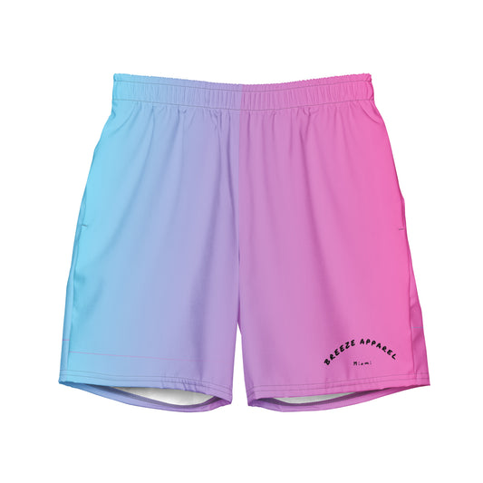 Men's swim trunks with a light-blue-to-pink design and a black 'Breeze Apparel Miami' word logo on the bottom-left knee