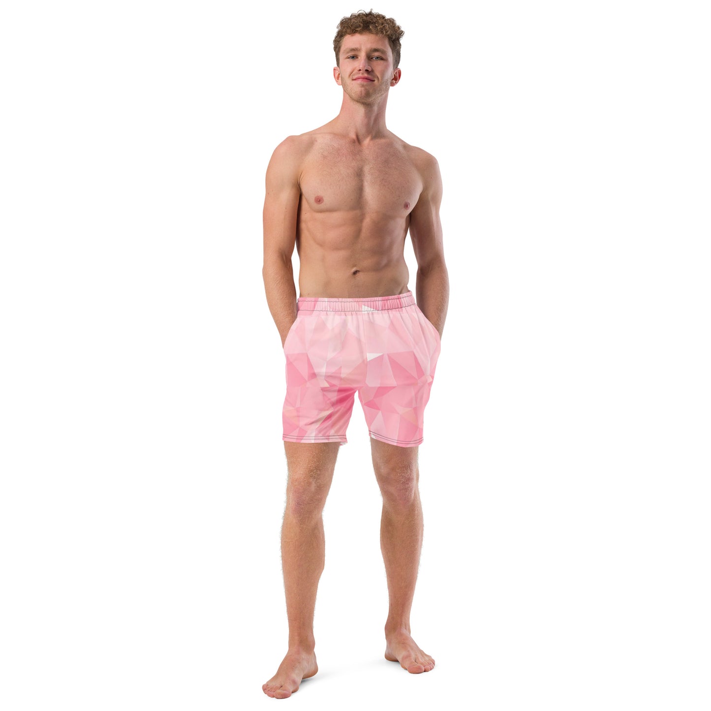 Man wearing swim trunks with pink geometric pattern.