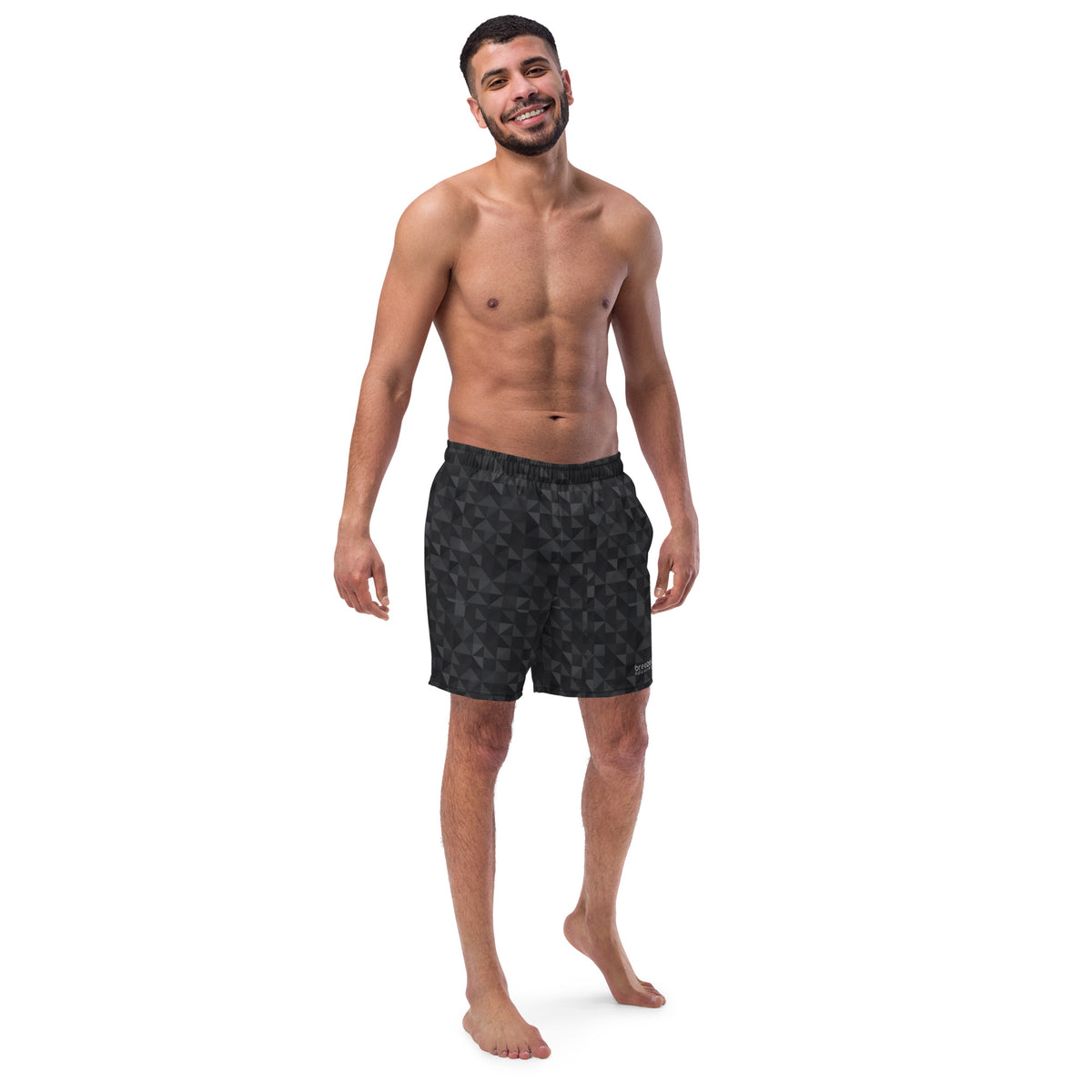 Man wearing swim trunks with black geometric pattern.