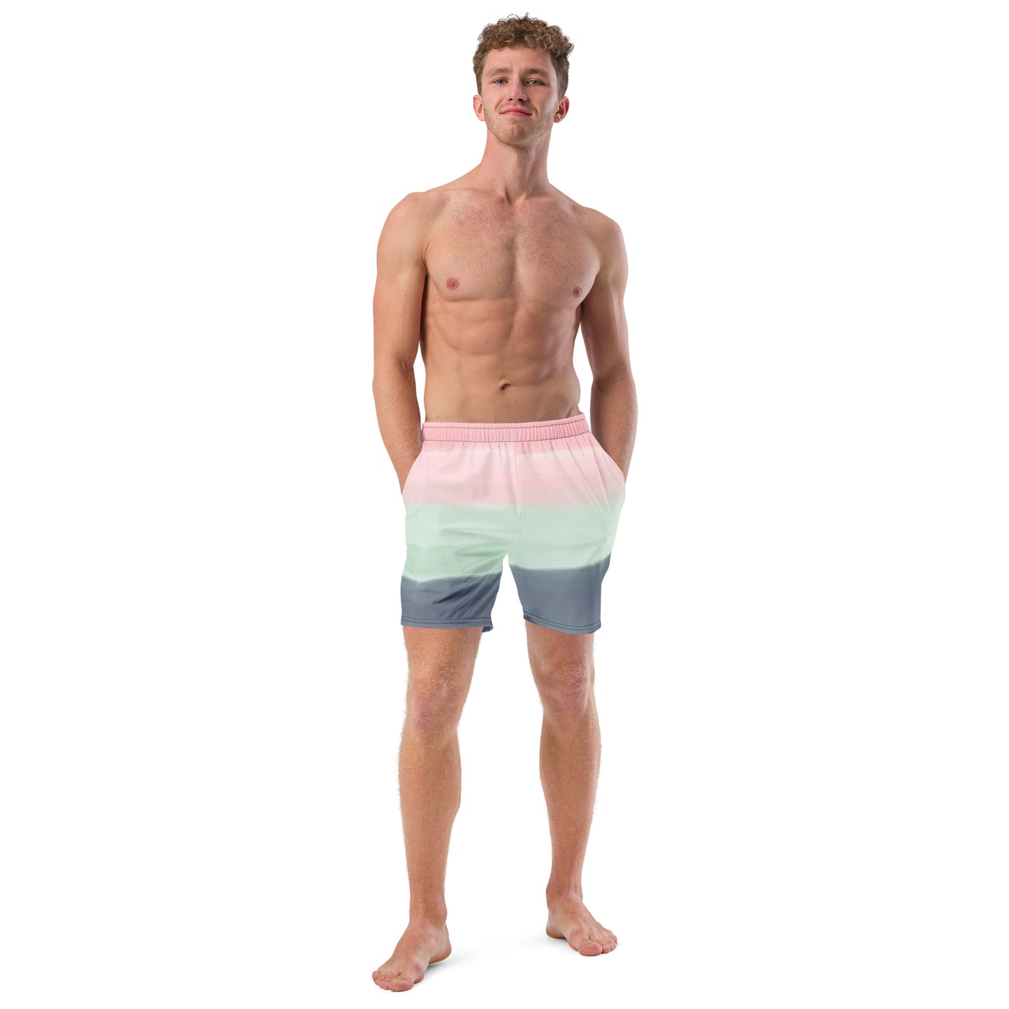 Man wearing swim trunks with color scheme of pink, light green, and gray, resembling watercolor.