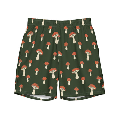 Swim trunks with pattern of mushrooms on a green background.