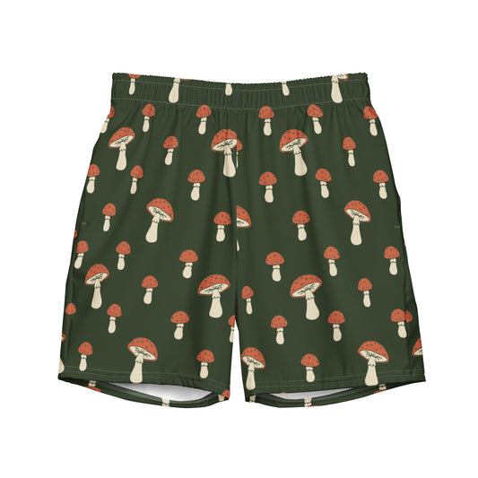 Swim trunks with pattern of mushrooms on a green background.