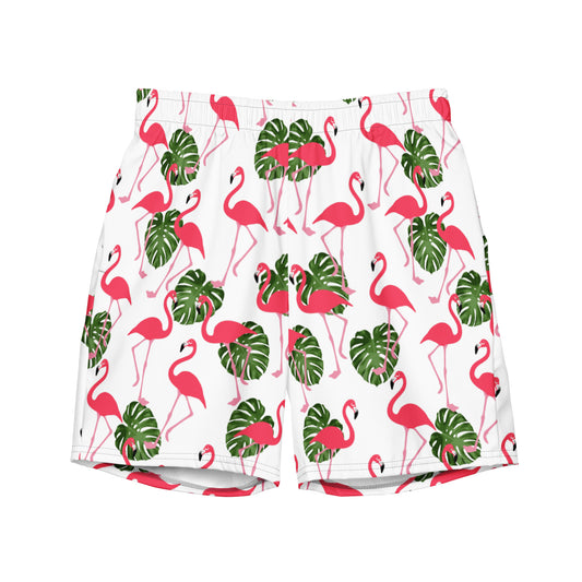 Swim trunks with pattern of pink flamingos and green leaves set on a white background.