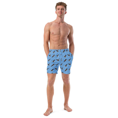 Man wearing blue swim trunks with pattern of bald eagles.