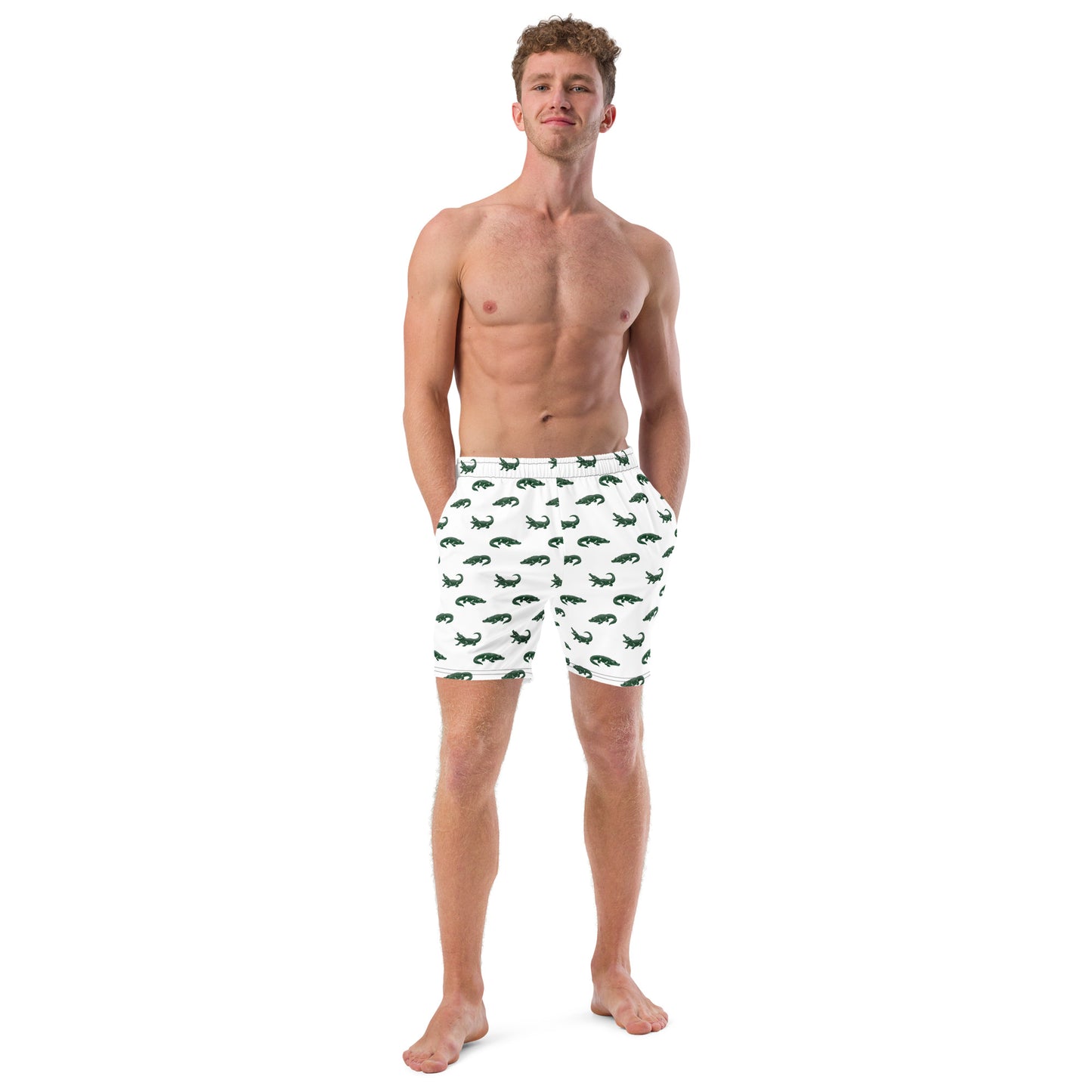 Man wearing white swim trunks with pattern of green alligators.