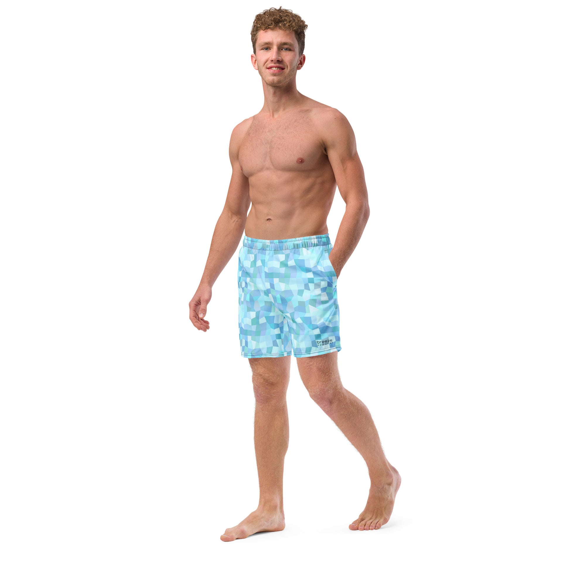 Man wearing swim trunks with light-blue geometric pattern.