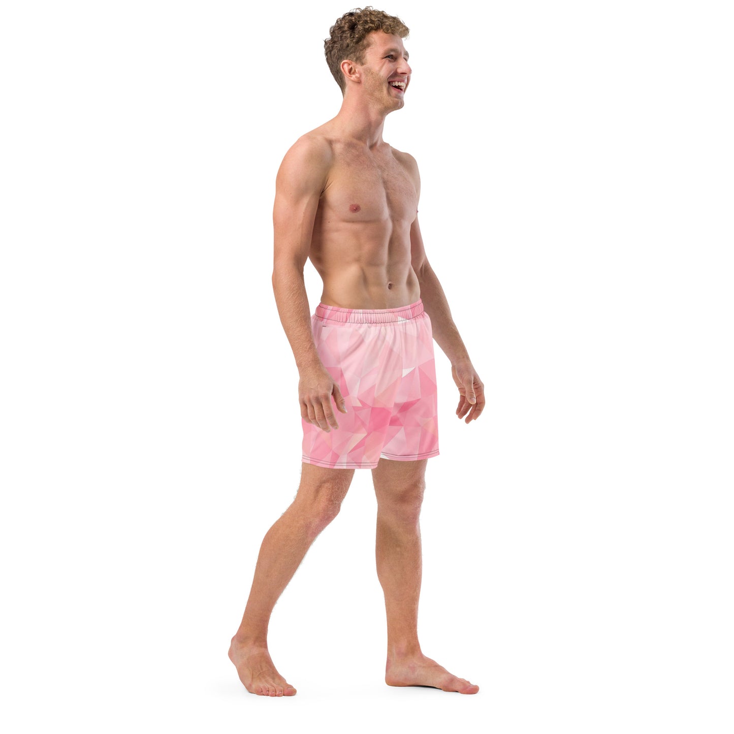 Man wearing swim trunks with pink geometric pattern.
