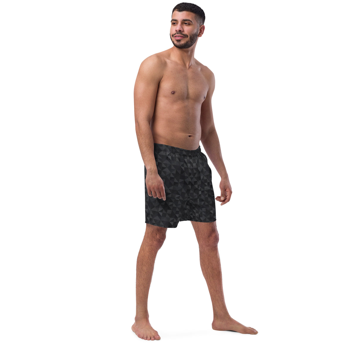 Man wearing swim trunks with black geometric pattern.