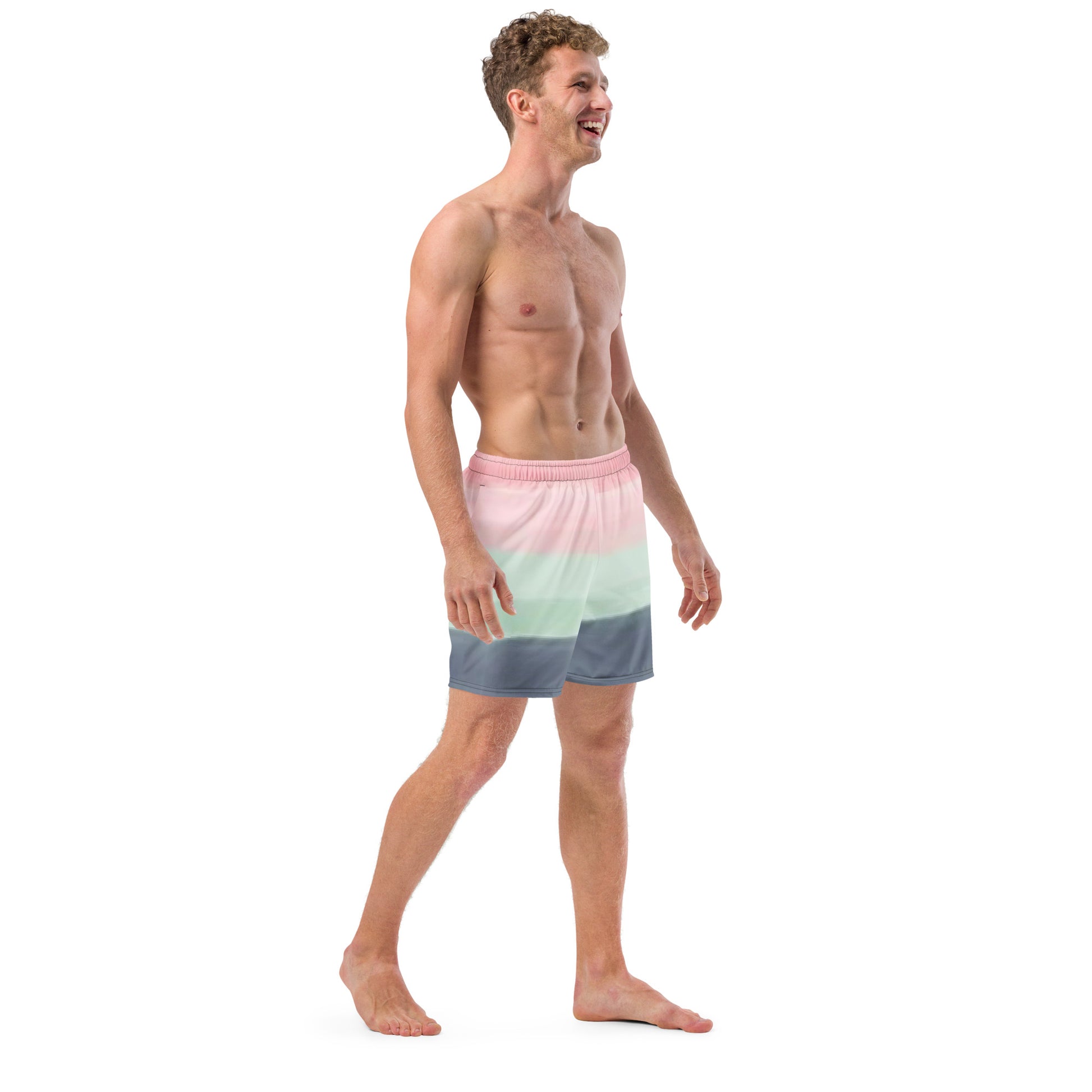 Man wearing swim trunks with color scheme of pink, light green, and gray, resembling watercolor.