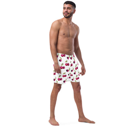 Man wearing swim trunks with pattern of cherries set on a white background.