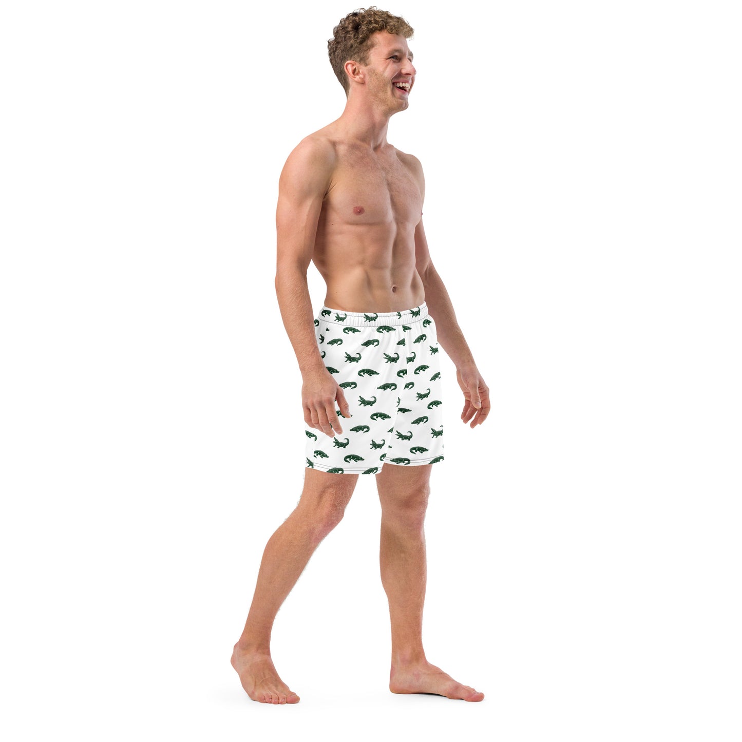 Man wearing white swim trunks with pattern of green alligators.