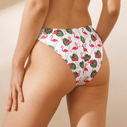 Rear view of woman wearing white bikini bottom with all-over flamingos design.