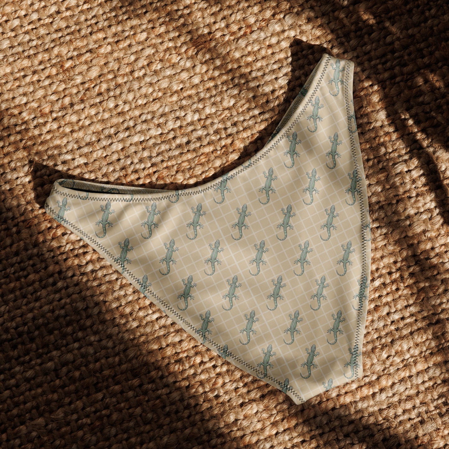 Beige bikini bottom with pattern of green geckos.
