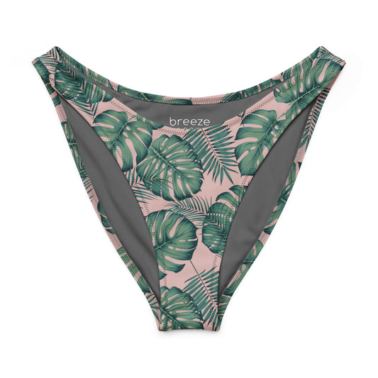 Bikini bottom with design of green palm leaves set on a pink background.