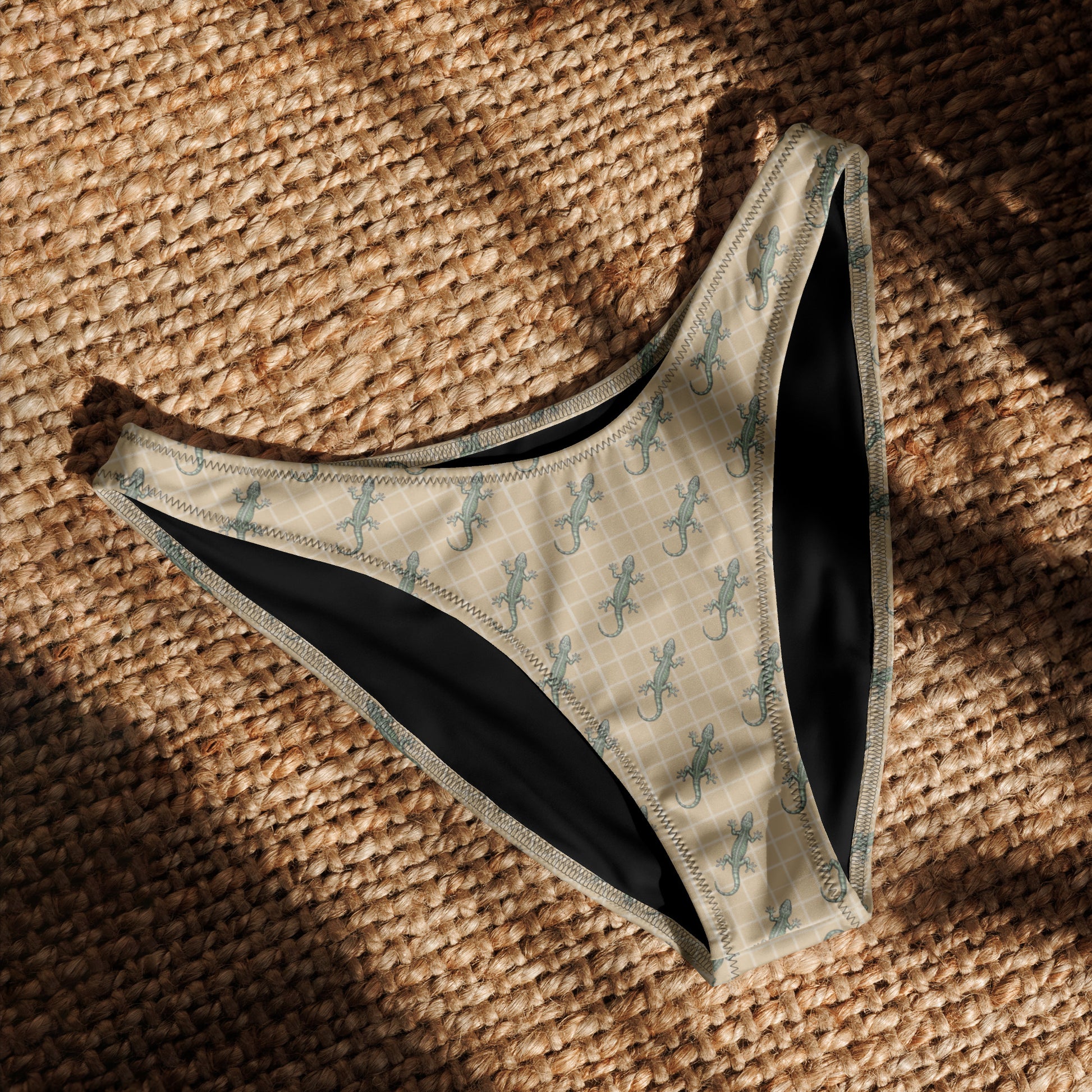 Beige bikini bottom with pattern of green geckos.