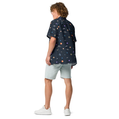 Man wearing button-down shirt with pattern of UFOs and planets in space.