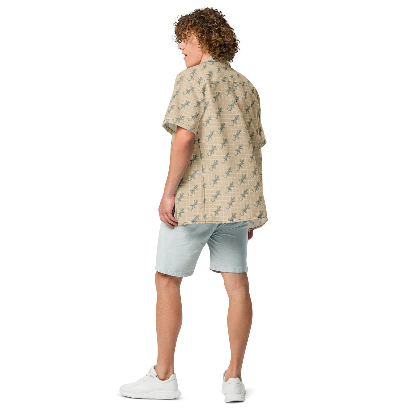 Man wearing beige button-down shirt with pattern of green geckos.