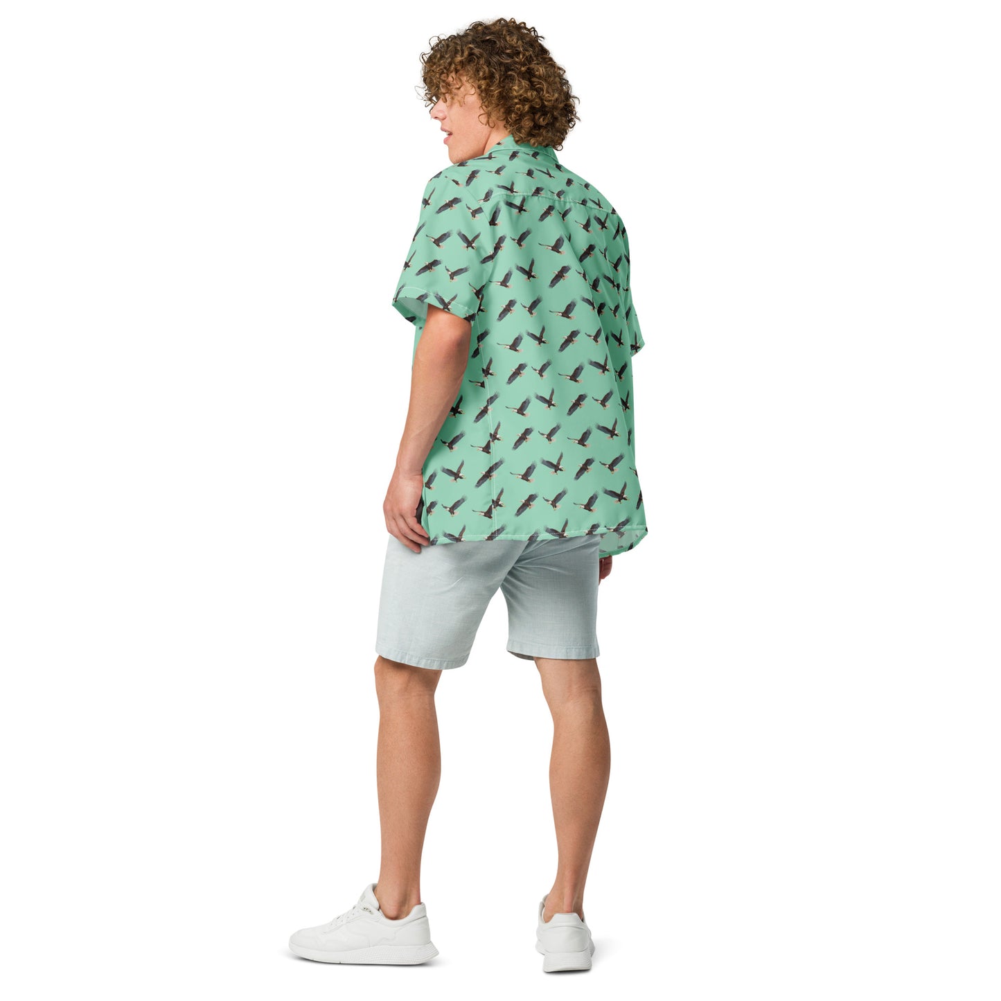 Man wearing green button-down shirt with pattern of bald eagles.