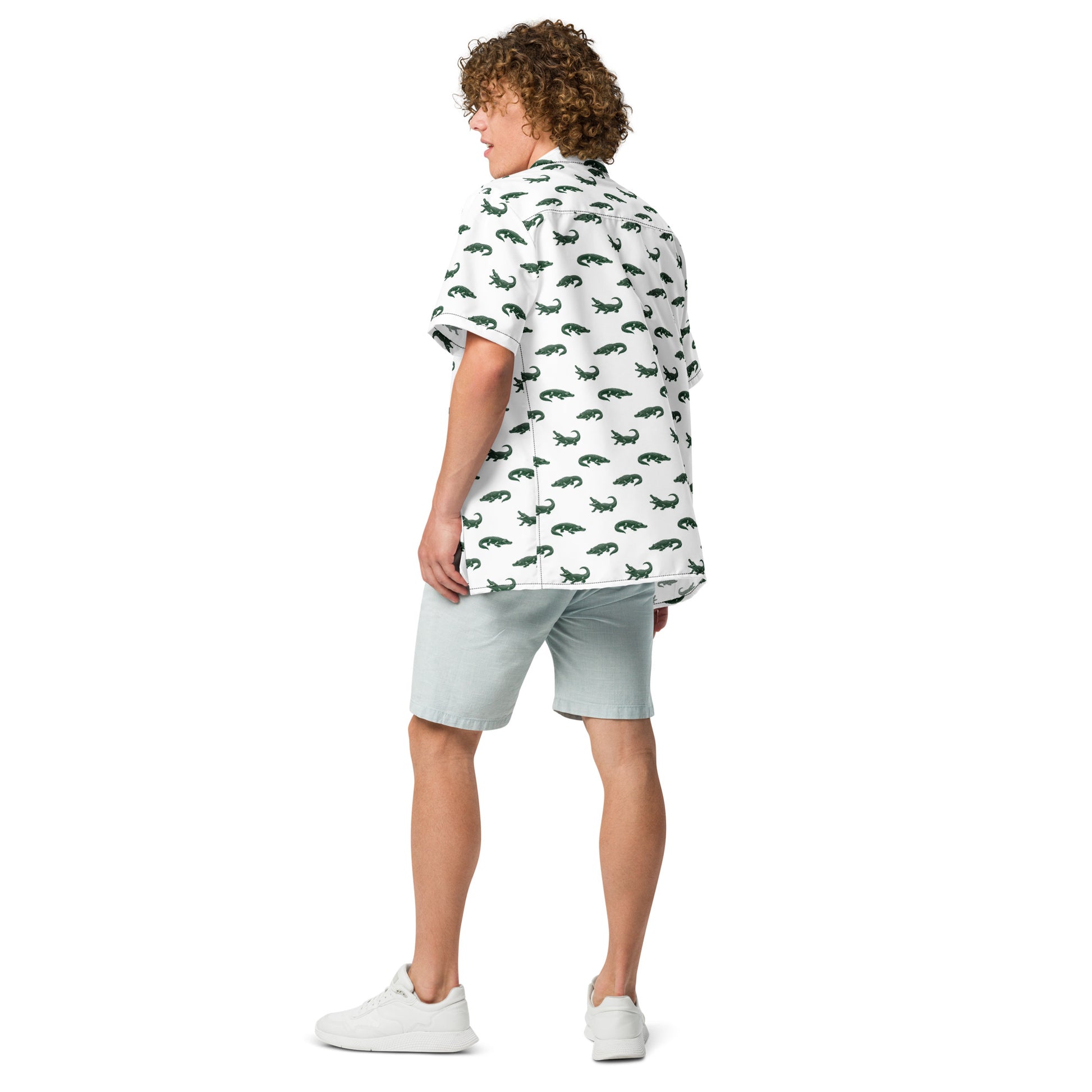 Man wearing white button-down shirt with pattern of green alligators.