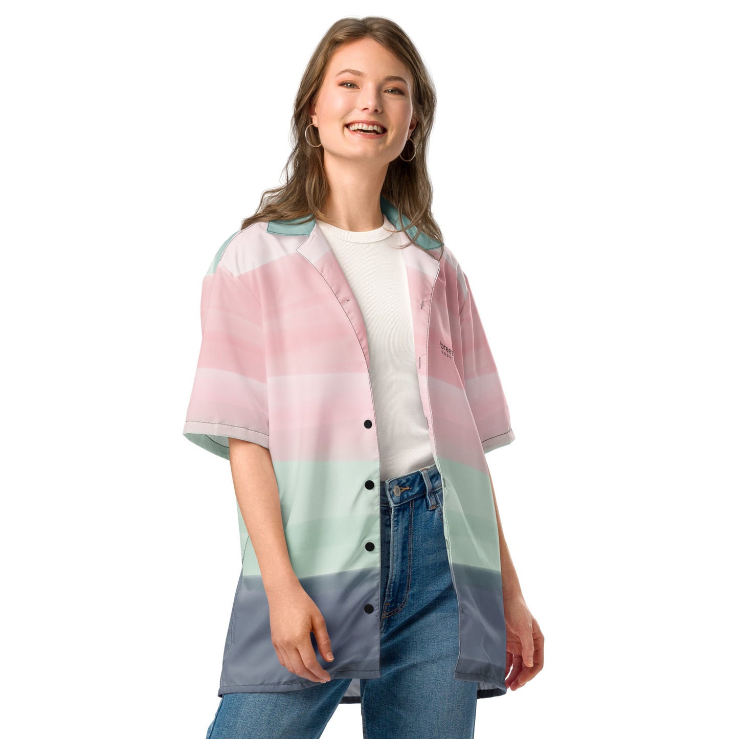 Woman wearing button-down shirt with pattern of horizontal stripes that are a shade of pink, mint green, or gray, resembling a watercolor design.