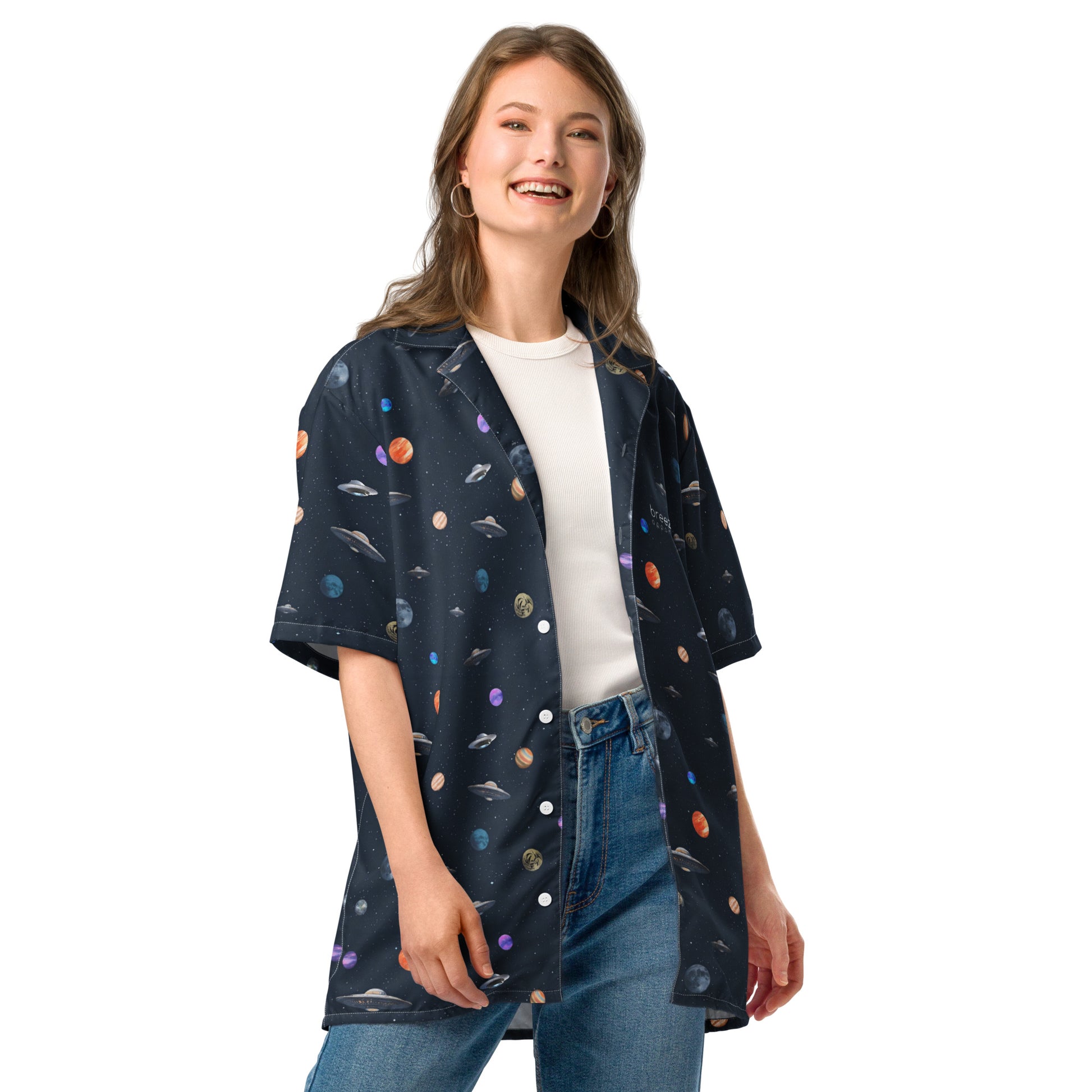 Woman wearing button-down shirt with pattern of UFOs and planets in space.