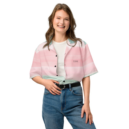 Woman wearing button-down shirt with pattern of horizontal stripes that are a shade of pink, mint green, or gray, resembling a watercolor design.