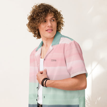 Man wearing button-down shirt with pattern of horizontal stripes that are a shade of pink, mint green, or gray, resembling a watercolor design.