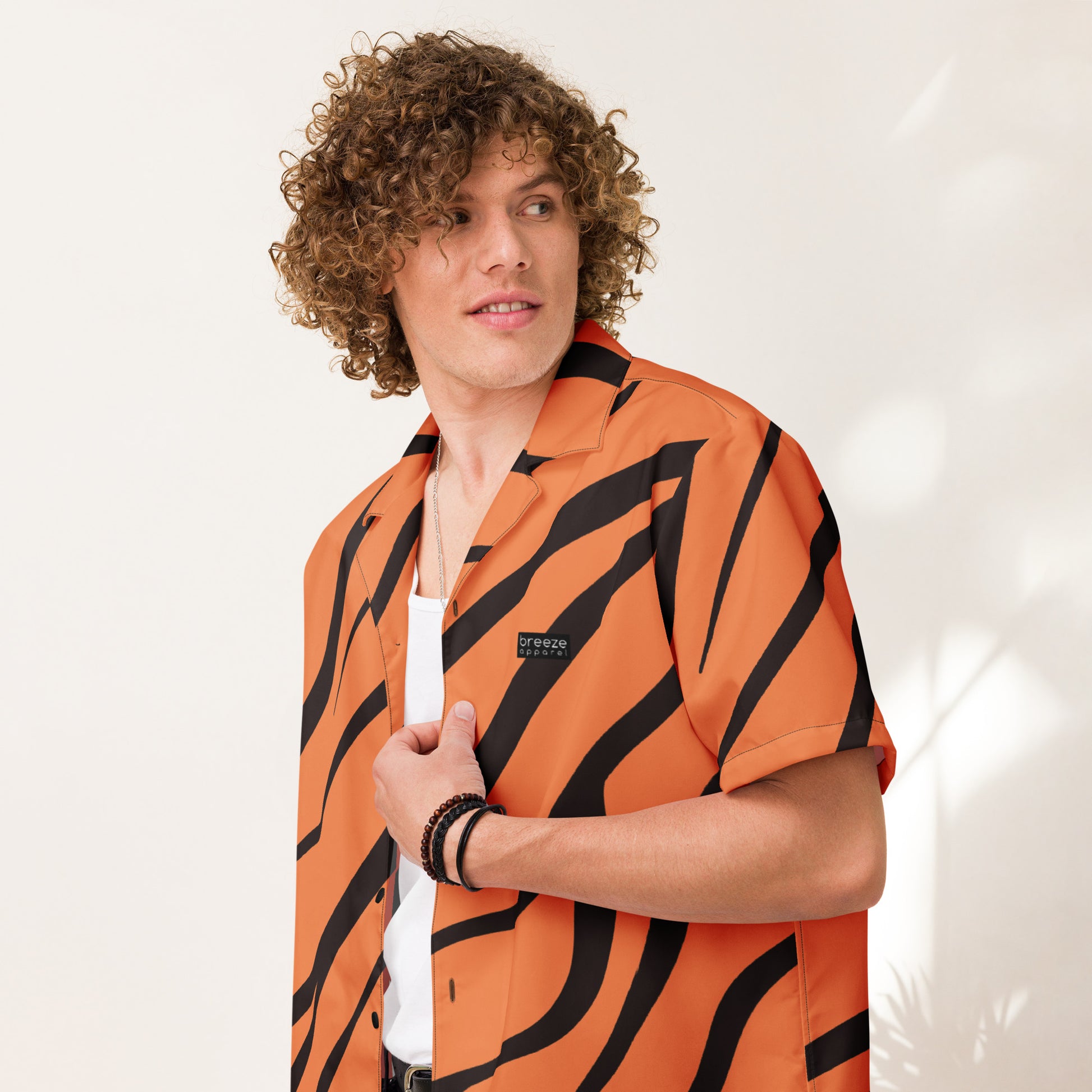 Man wearing button-down shirt with tigerskin pattern.