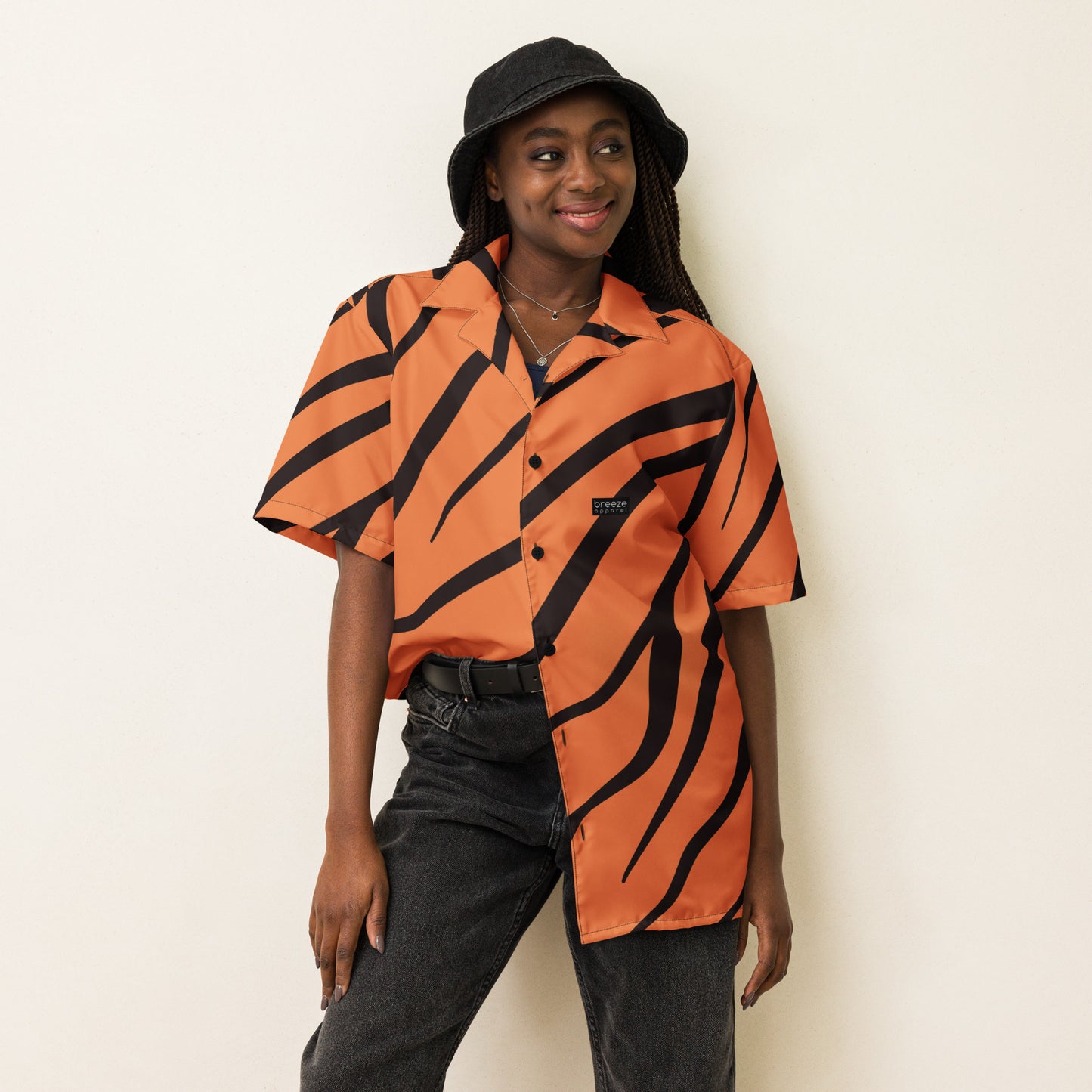 Woman wearing button-down shirt with tigerskin pattern.