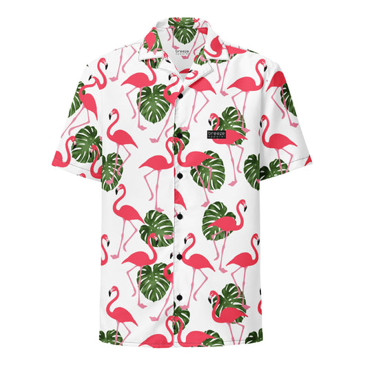 Button-down shirt with pattern of flamingos and green palm leaves set on a white background.