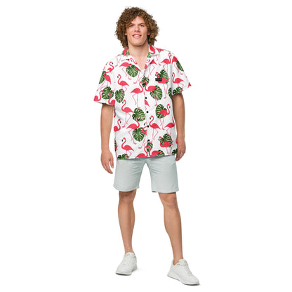 Man wearing button-down shirt with pattern of flamingos and green palm leaves set on a white background.