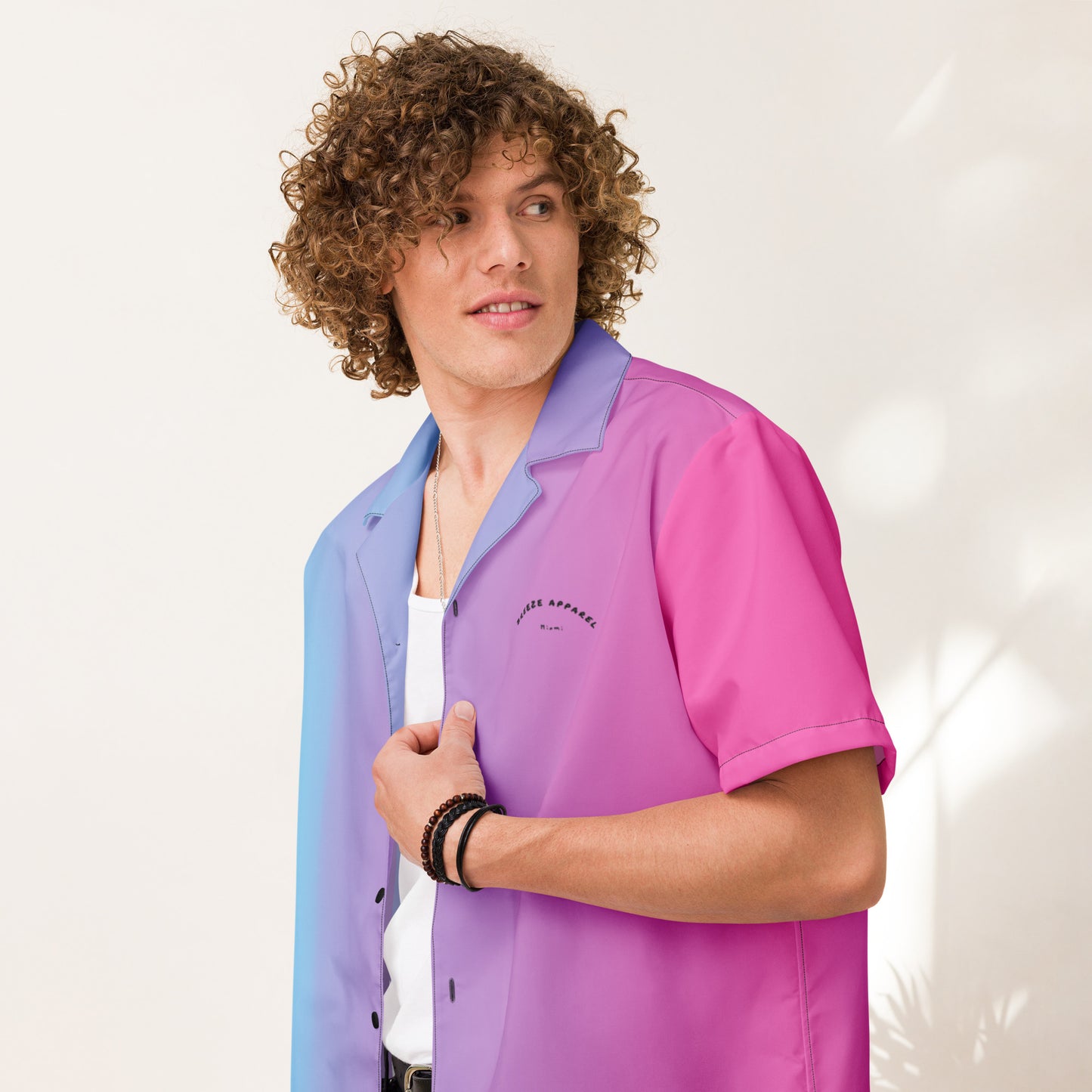 Man wearing button-down shirt with color scheme that fades from light blue, to purple, to pink.