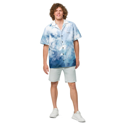 Man wearing button-down shirt with blue-white pattern resembling watercolor.