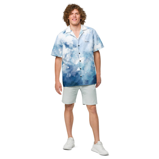 Man wearing button-down shirt with blue-white pattern resembling watercolor.