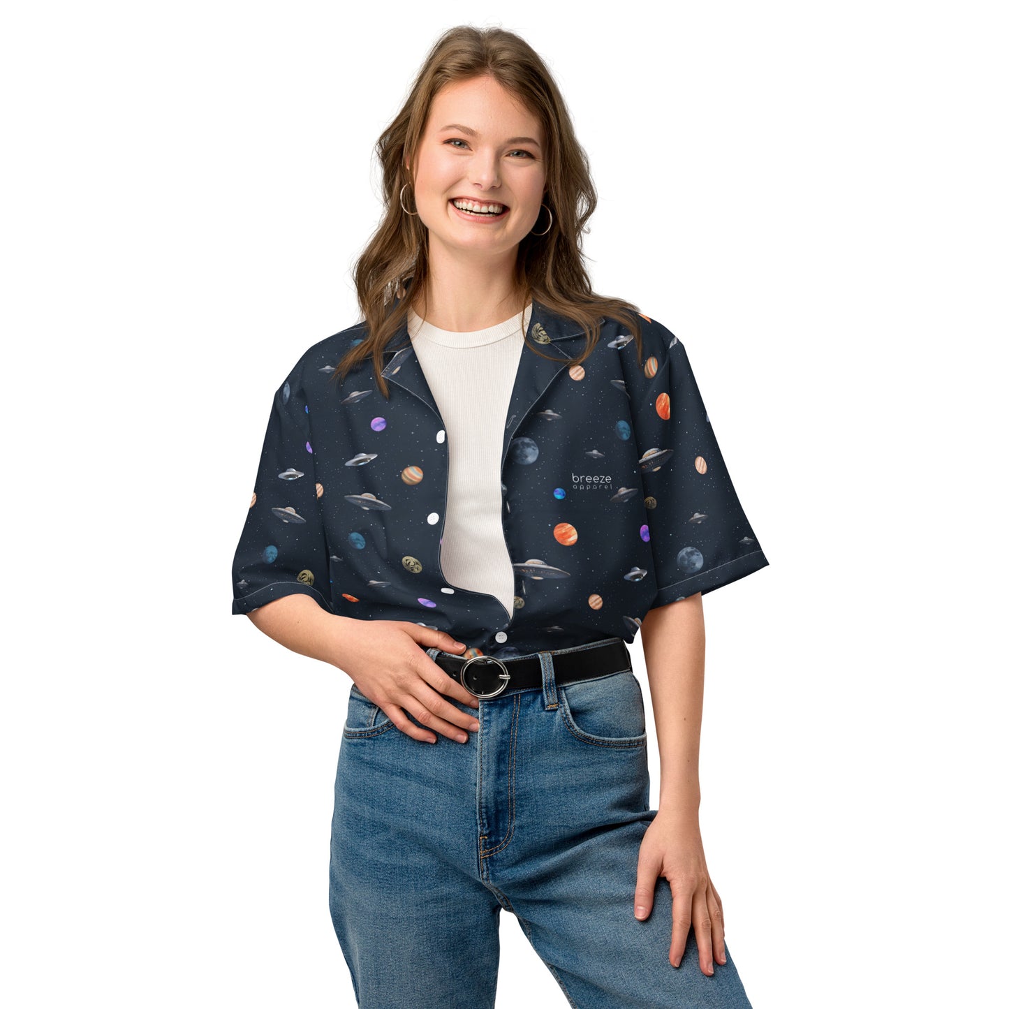 Woman wearing button-down shirt with pattern of UFOs and planets in space.