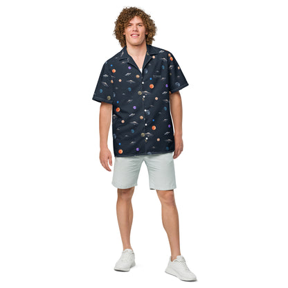 Man wearing button-down shirt with pattern of UFOs and planets in space.