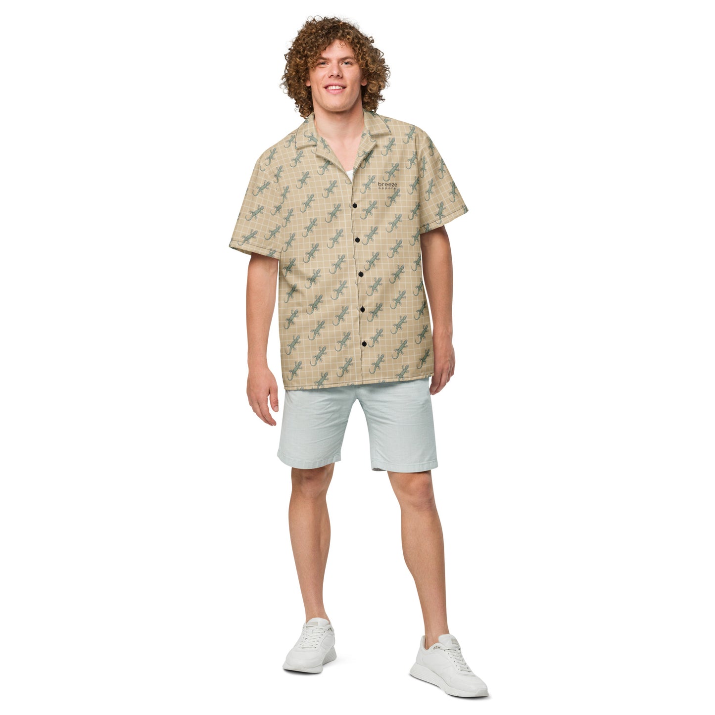 Man wearing beige button-down shirt with pattern of green geckos.