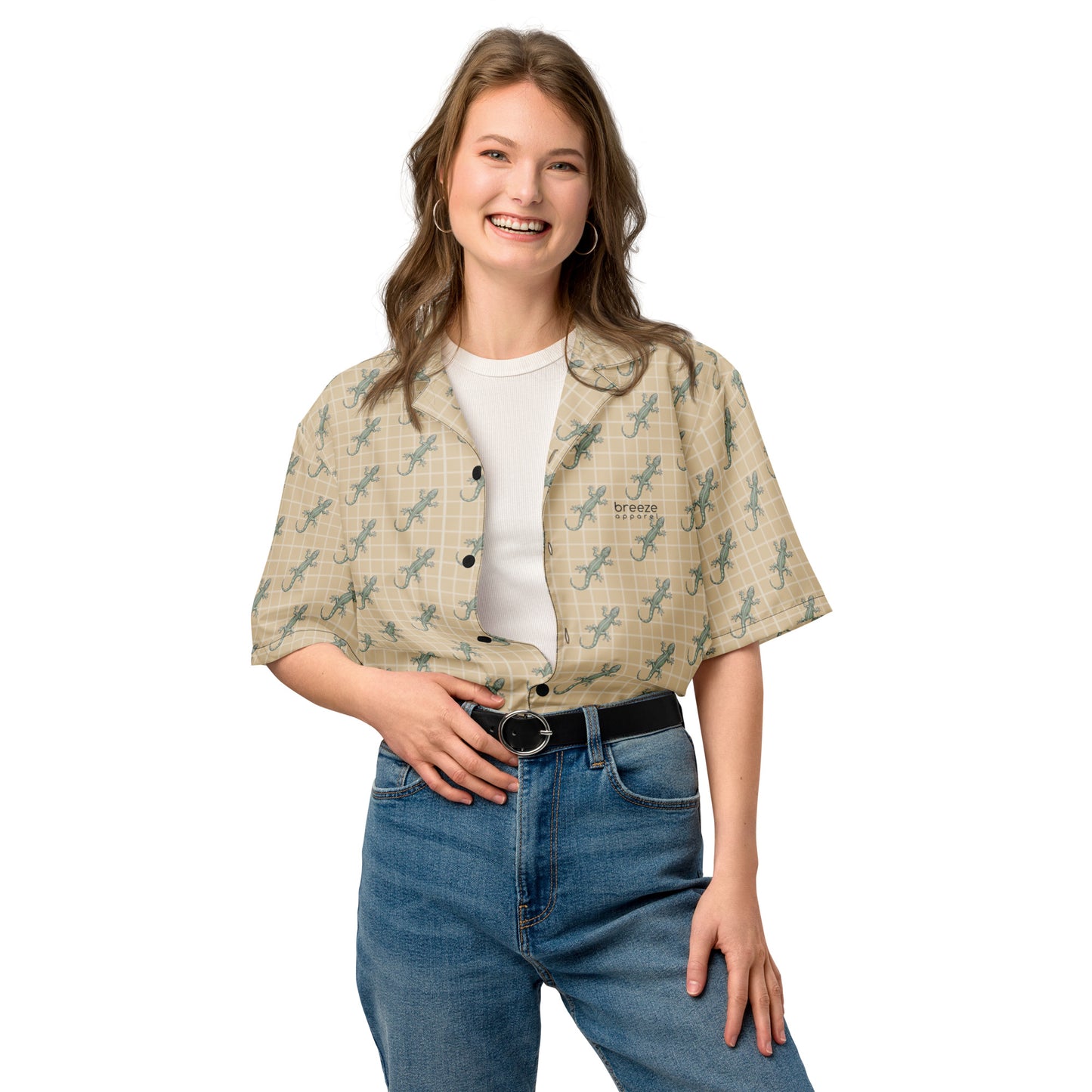 Woman wearing beige button-down shirt with pattern of green geckos.