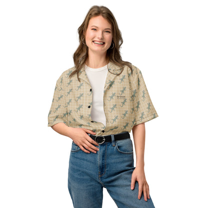 Woman wearing beige button-down shirt with pattern of green geckos.