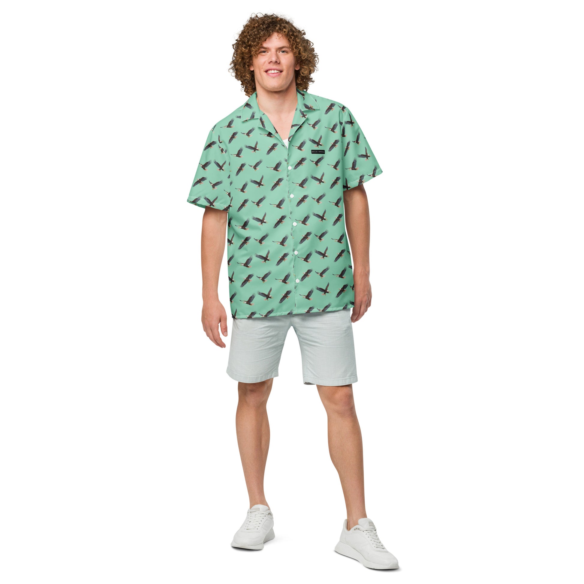 Man wearing green button-down shirt with pattern of bald eagles.