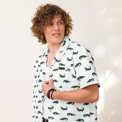 Man wearing white button-down shirt with pattern of green alligators.