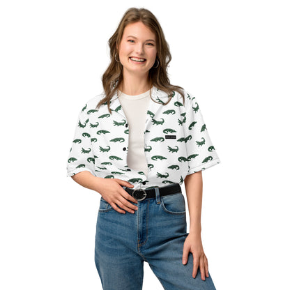 Woman wearing white button-down shirt with pattern of green alligators.