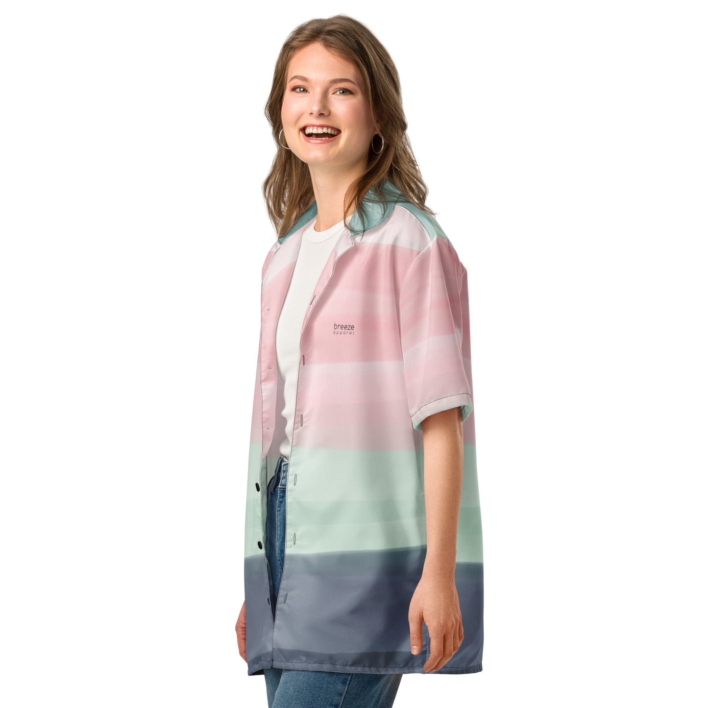 Woman wearing button-down shirt with pattern of horizontal stripes that are a shade of pink, mint green, or gray, resembling a watercolor design.
