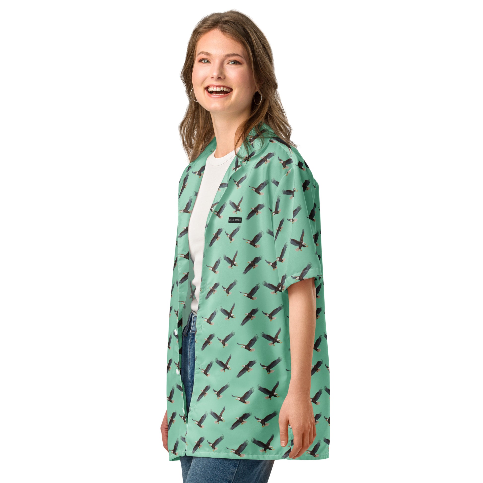 Woman wearing green button-down shirt with pattern of bald eagles.
