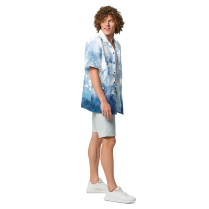 Man wearing button-down shirt with blue-white pattern resembling watercolor.