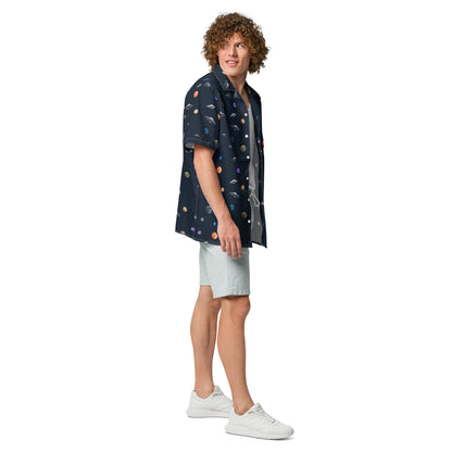 Man wearing button-down shirt with pattern of UFOs and planets in space.