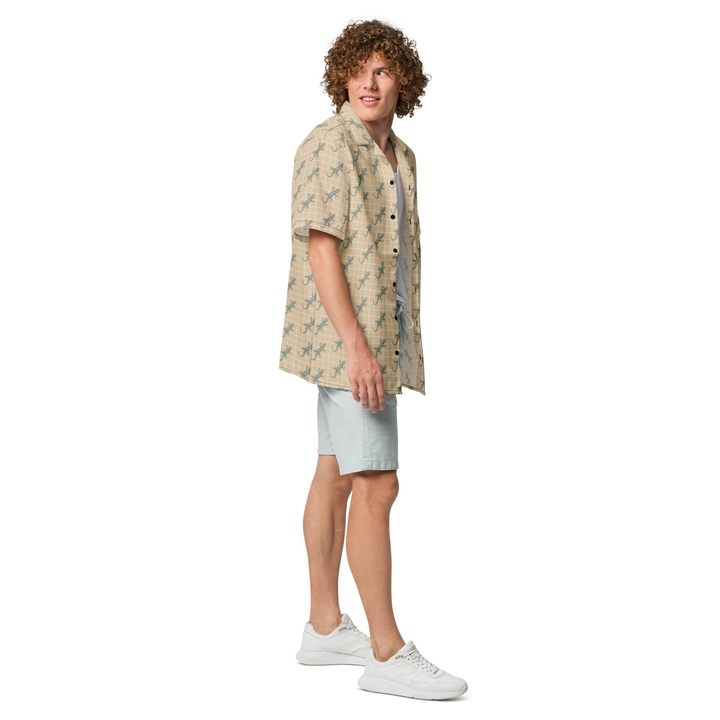 Man wearing beige button-down shirt with pattern of green geckos.
