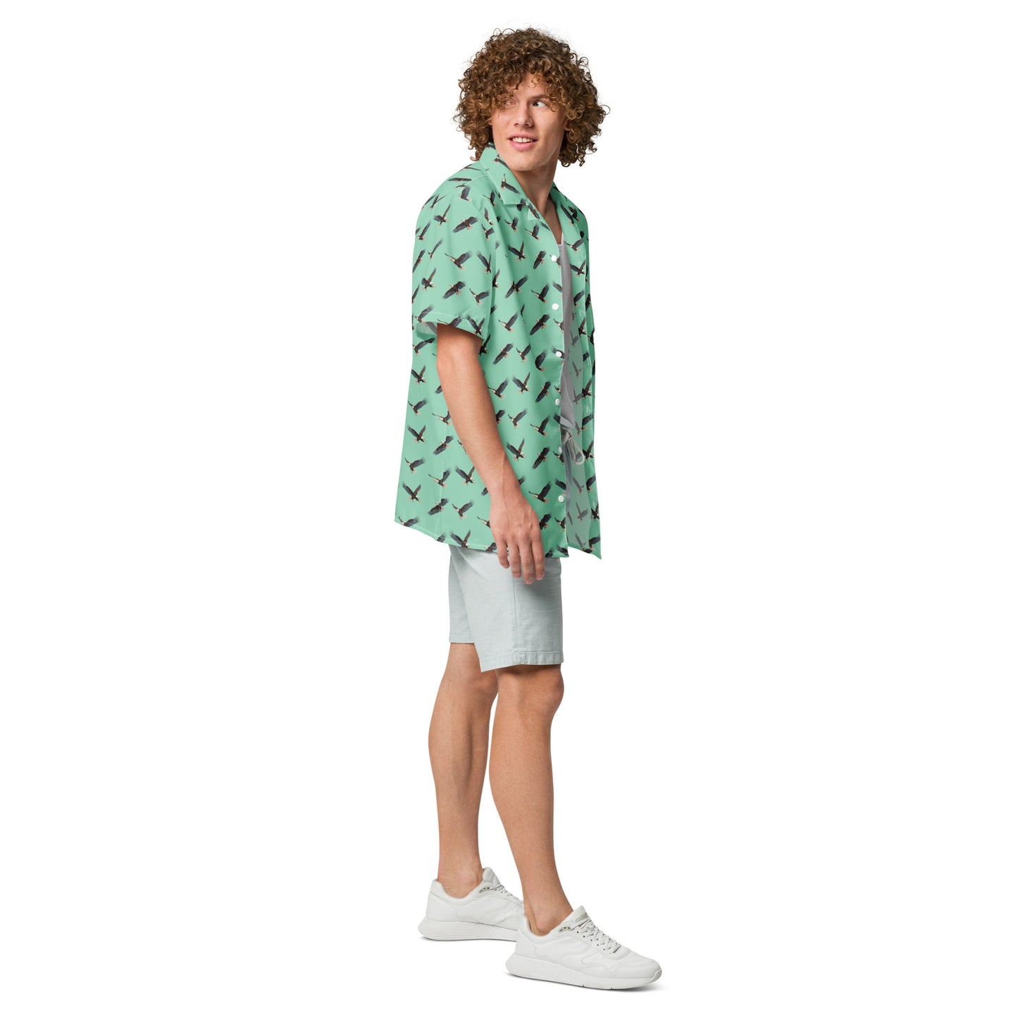 Man wearing green button-down shirt with pattern of bald eagles.